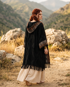 Close up portrait of model wearing boho kimono with beaded necklace