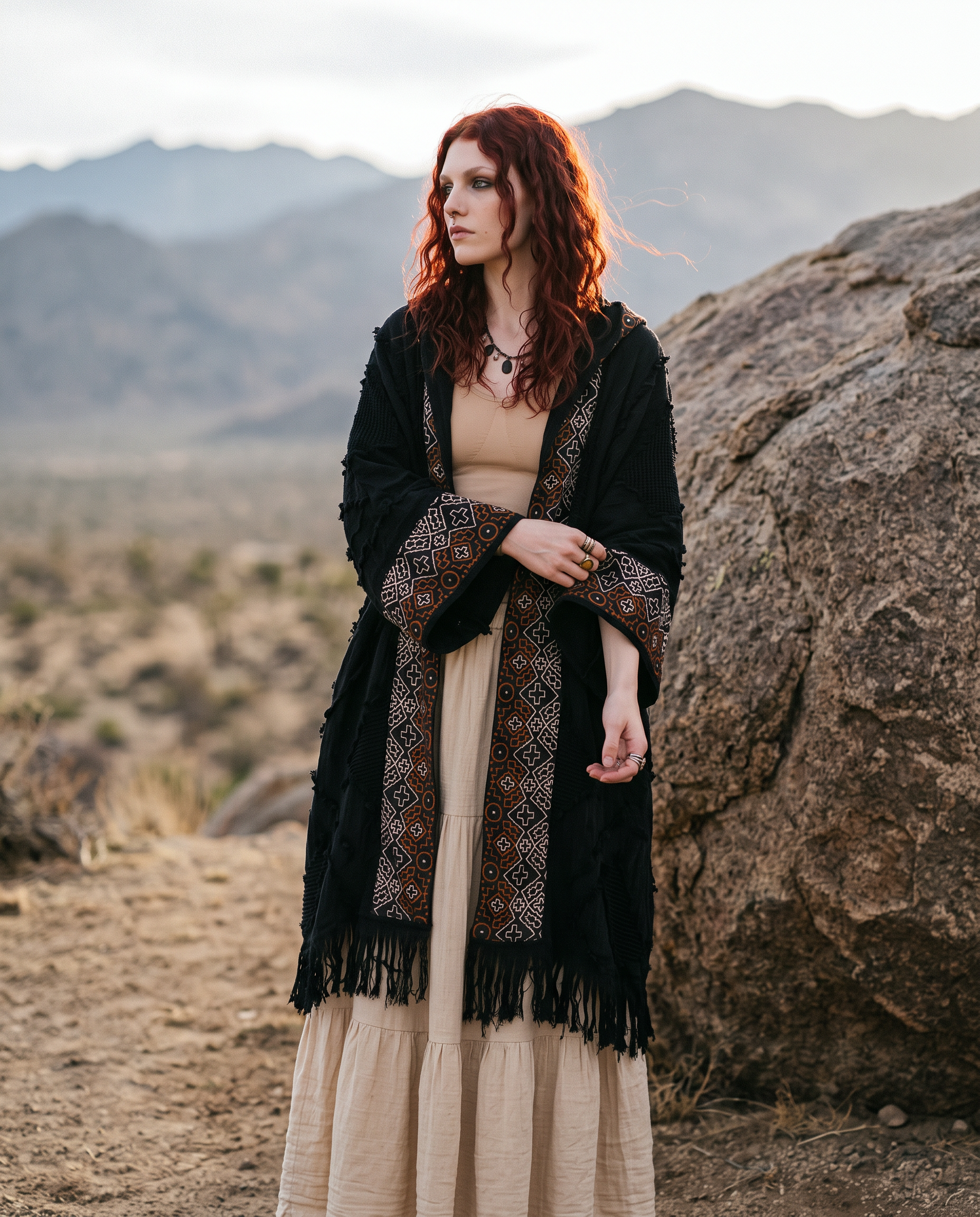 Model wearing hooded kimono over cream maxi skirt in mountain setting